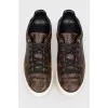 Sneakers in the print of the log of brand