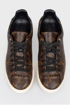 Sneakers in the print of the log of brand
