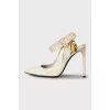 Patent leather slingbacks with a gold pendant