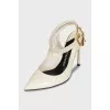 Patent leather slingbacks with a gold pendant