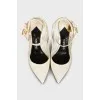 Patent leather slingbacks with a gold pendant