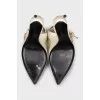 Patent leather slingbacks with a gold pendant