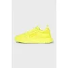 Yellow leather sneakers with the brand logo