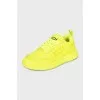 Yellow leather sneakers with the brand logo