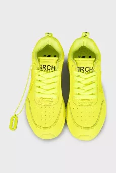Yellow leather sneakers with the brand logo