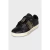 Black leather sneakers decorated with studs