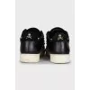 Black leather sneakers decorated with studs