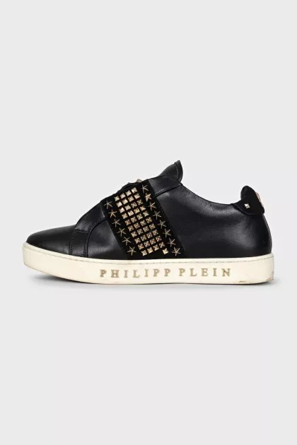 Black leather sneakers decorated with studs