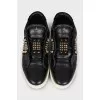 Black leather sneakers decorated with studs