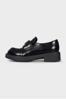 Black leather loafers with silver logo