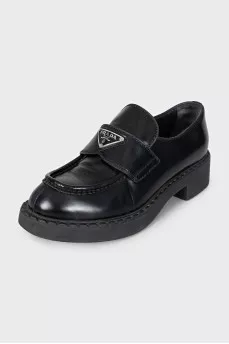 Black leather loafers with silver logo