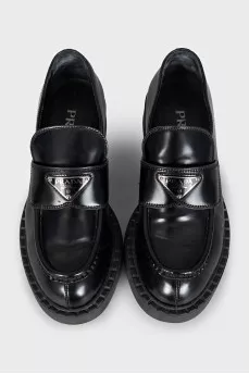 Black leather loafers with silver logo