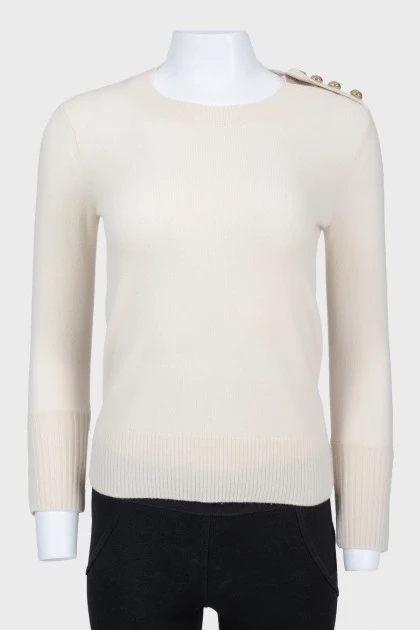 Beige sweater with cuffs on buttons