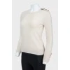 Beige sweater with cuffs on buttons