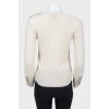 Beige sweater with cuffs on buttons