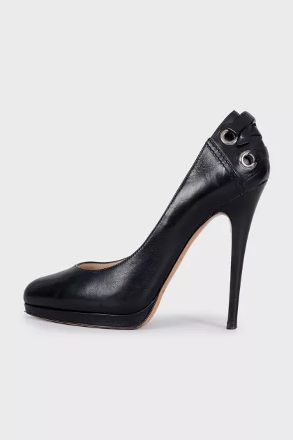 Black leather shoes with embellishments on the back