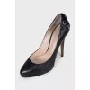 Black leather shoes with embellishments on the back