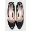 Black leather shoes with embellishments on the back