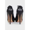 Black leather shoes with embellishments on the back