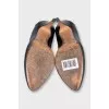 Black leather shoes with embellishments on the back