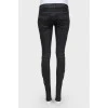 Black jeans of medium planting with lightning on trousers