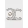 Silver logo brooch with rhinestones