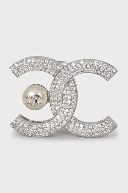 Silver logo brooch with rhinestones