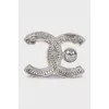 Silver logo brooch with rhinestones
