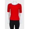 Red top with lacing on the back with a tag