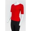 Red top with lacing on the back with a tag