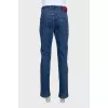 Men's blue jeans with a red stripe