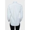 White shirt with blue embroidered brand logo