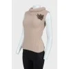 Beige knitted vest with brooch