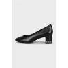 Black leather shoes with decorated heels