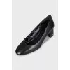 Black leather shoes with decorated heels