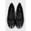 Black leather shoes with decorated heels