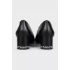 Black leather shoes with decorated heels