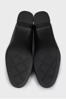 Black leather shoes with decorated heels