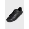 Black leather sneakers with a decorated heel