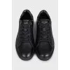 Black leather sneakers with a decorated heel