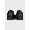 Black leather sneakers with a decorated heel