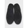 Black leather sneakers with a decorated heel