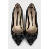 Patent leather shoes decorated with a bow