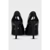 Patent leather shoes decorated with a bow