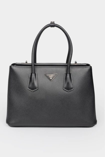 Black leather bag on pens on a rotary fastener
