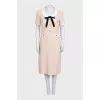 Fitted dress decorated with gold buttons