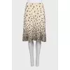 The beige skirt is decorated with sequins