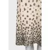 The beige skirt is decorated with sequins