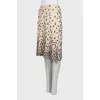 The beige skirt is decorated with sequins