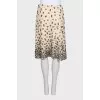 The beige skirt is decorated with sequins